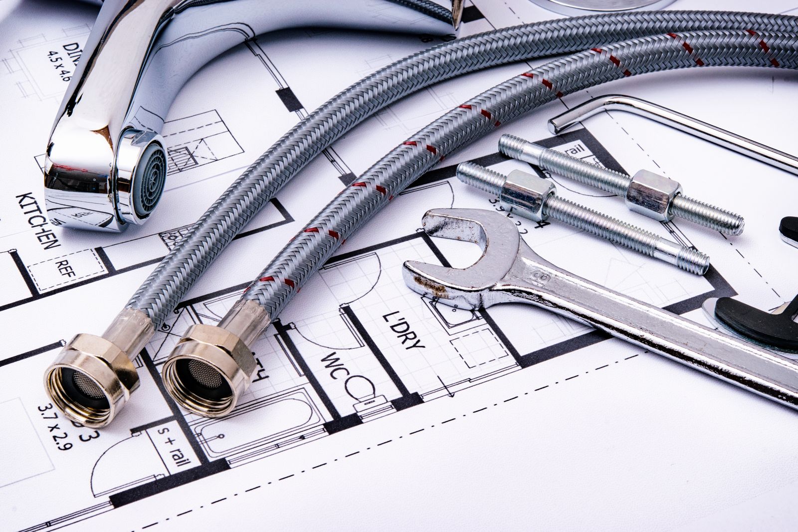 Faucet supply lines and wrenches on a plan