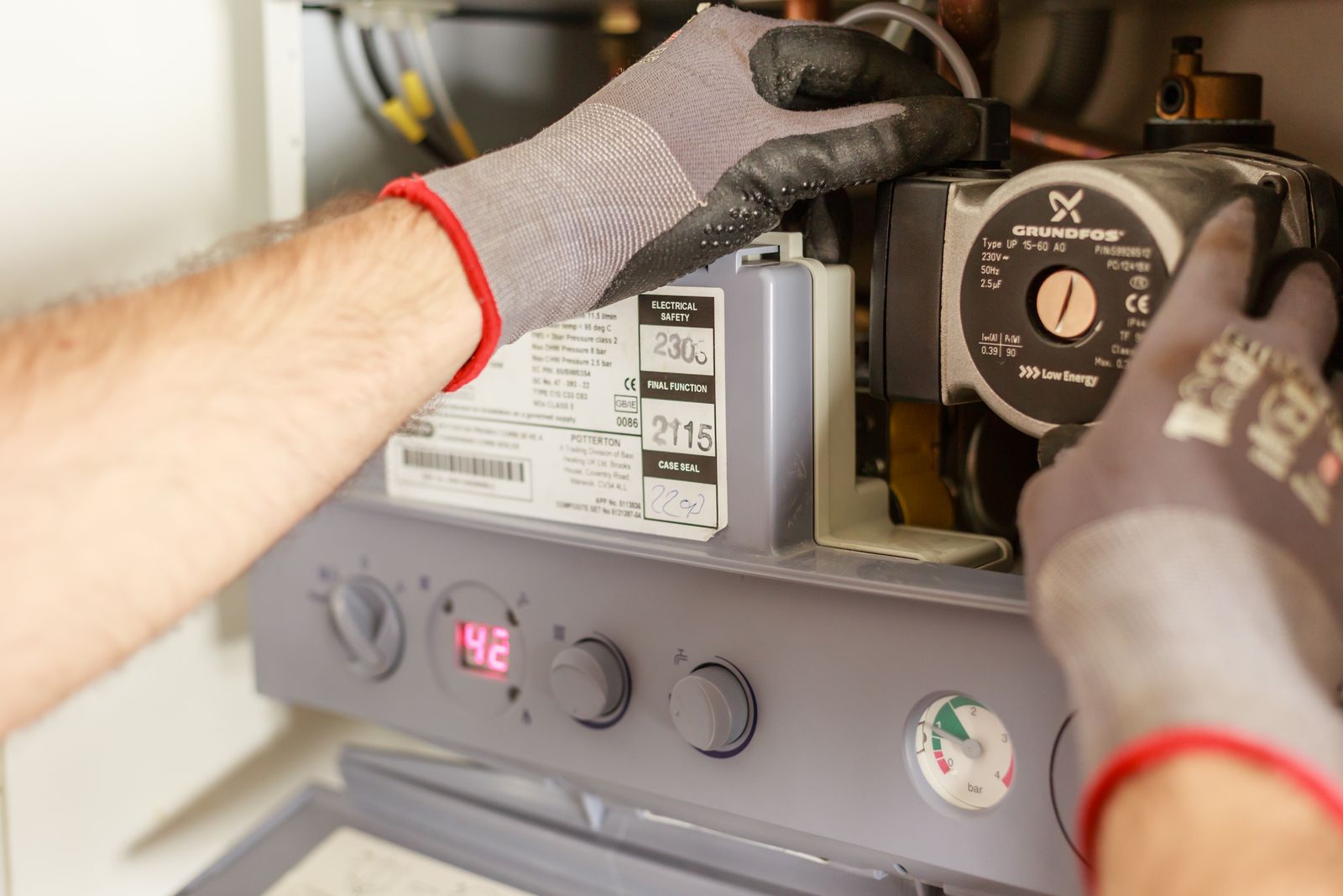 Technician adjusting a boiler circulation pump