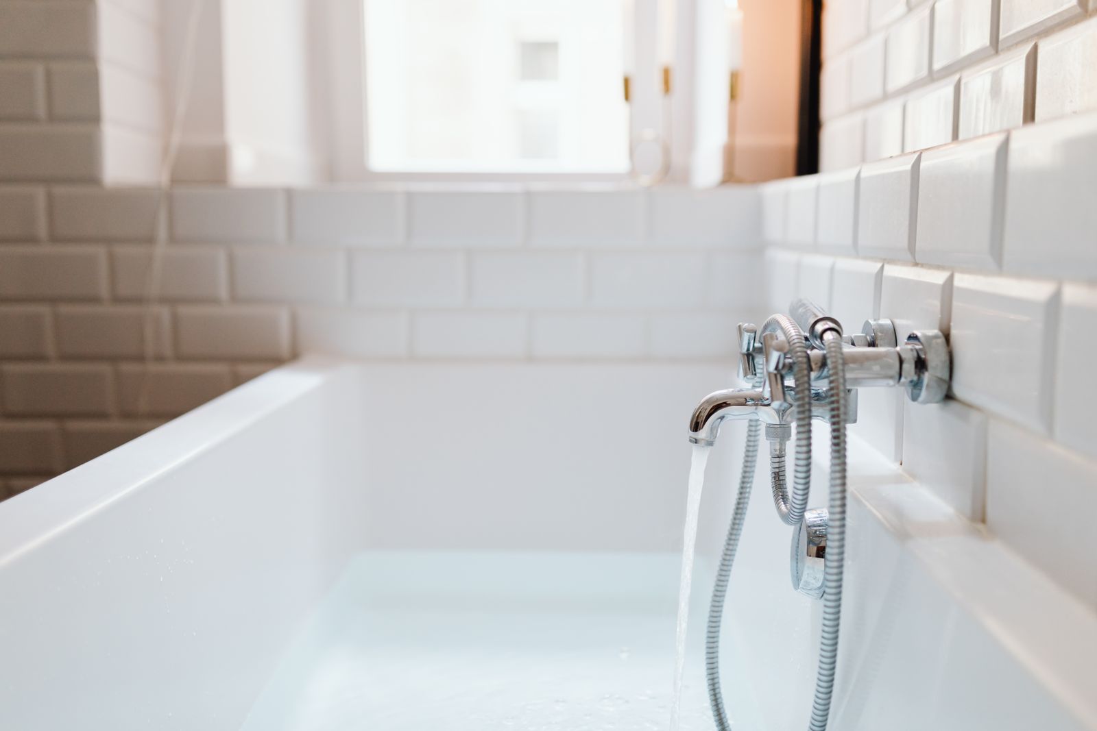 Bathtub with a chrome faucet and fixtures